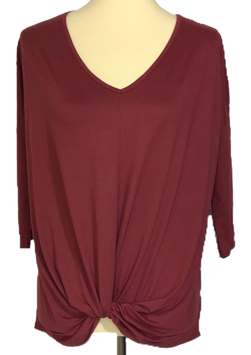 Rust colored flowy top featuring 3/4 length sleeves.