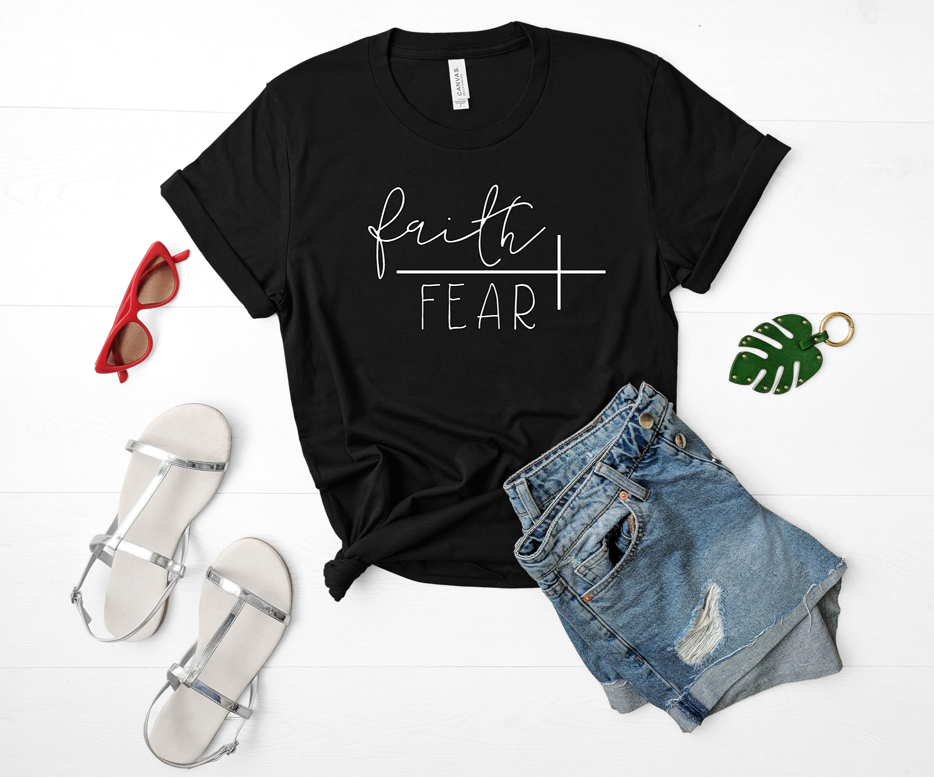 tee in black with white vinyl flat lay